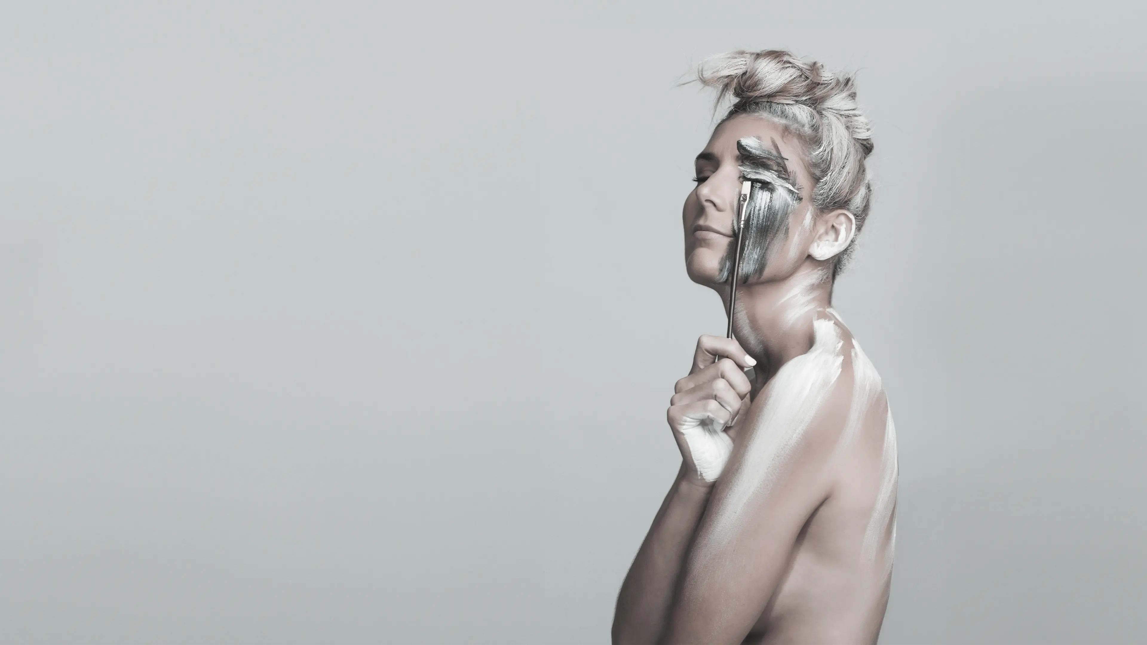 Adele Grace a South African artist with artistic makeup on a plain background